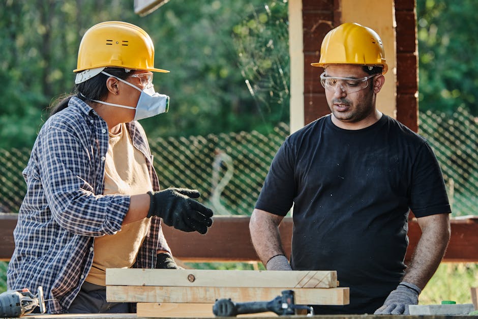 Experienced renovation contractors team collaborating on construction project site