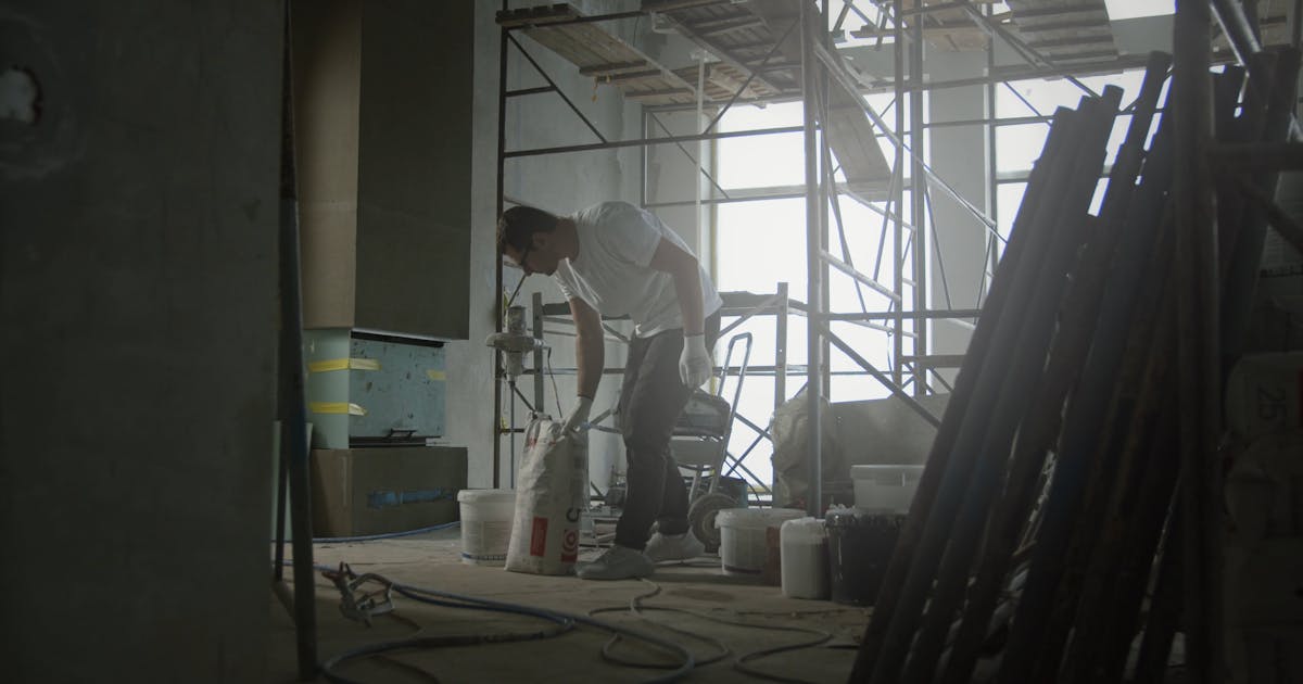 Interior renovation under way, with scaffolding and buckets of mortar on the floor